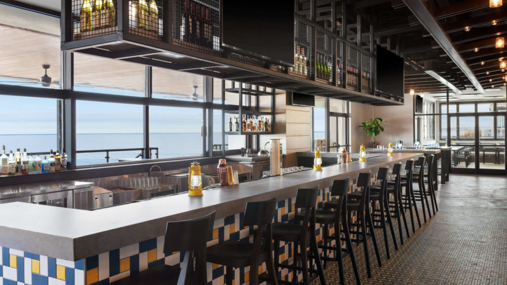 Enjoy dining with a view of the Chesapeake Bay at Tin Cup Kitchen + Oyster Bar at Delta Hotels by Marriott Virginia Beach Bayfront Suites. 