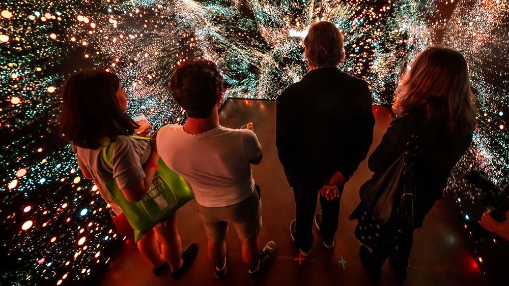 people looking at illuminated hall