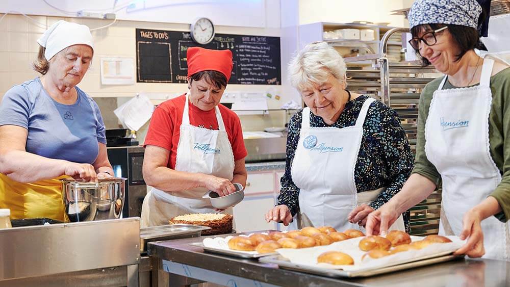 4 elderly women bake goods