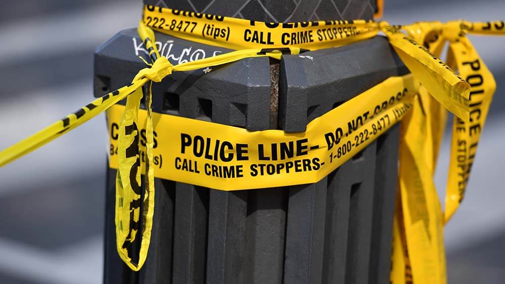 Police crime scene tape on pole