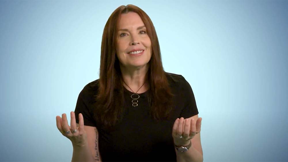 woman with dark hair speaking to camera