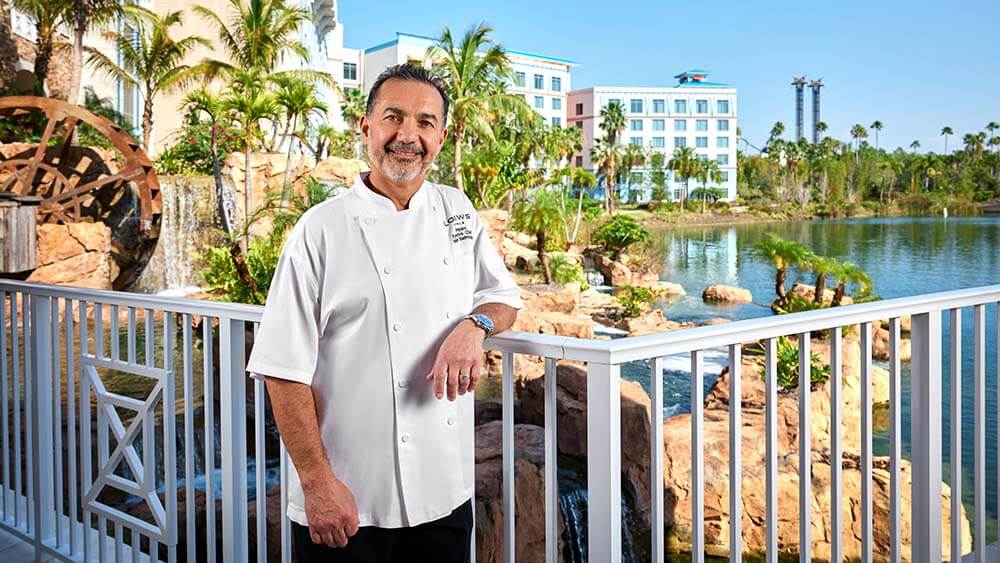 Chef posing in front of tropical garden