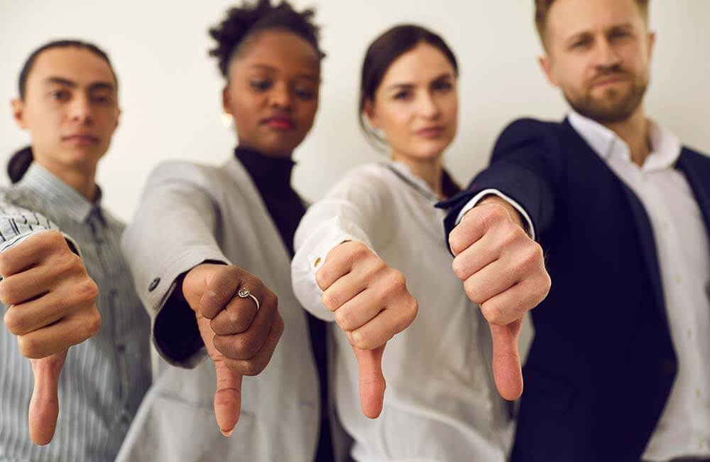diverse employees giving thumbs down sign
