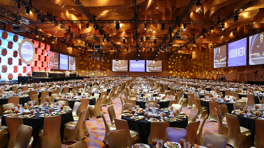 large banquet space with hundreds of tables set for event