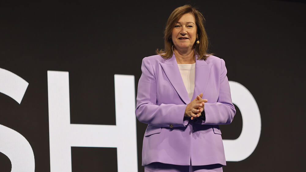 woman speaking wearing lilac colored blazer