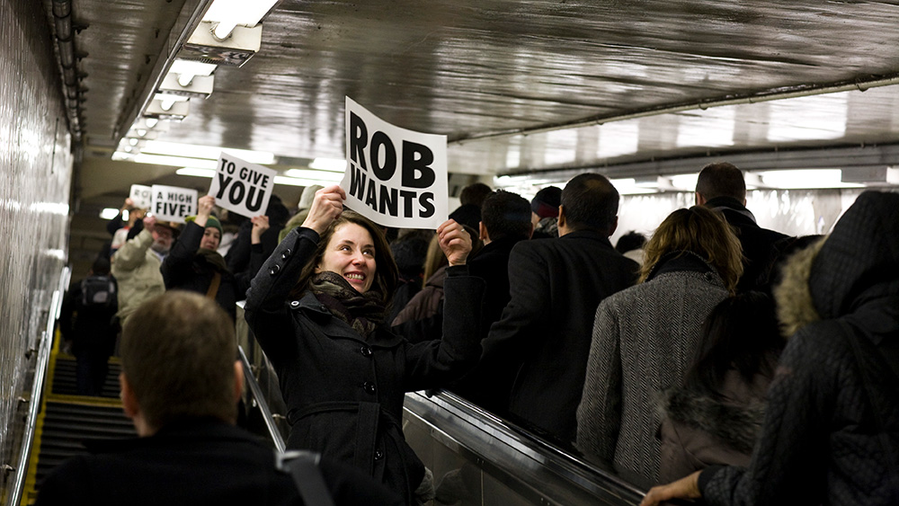 people holding signs on escalator