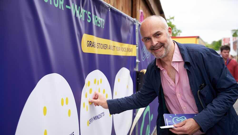 Attendees at the latest Creative Bureaucracy Festival in Berlin moving between stages outdoors had to pass through a passageway lined by fences that kept a messy construction area out of view.