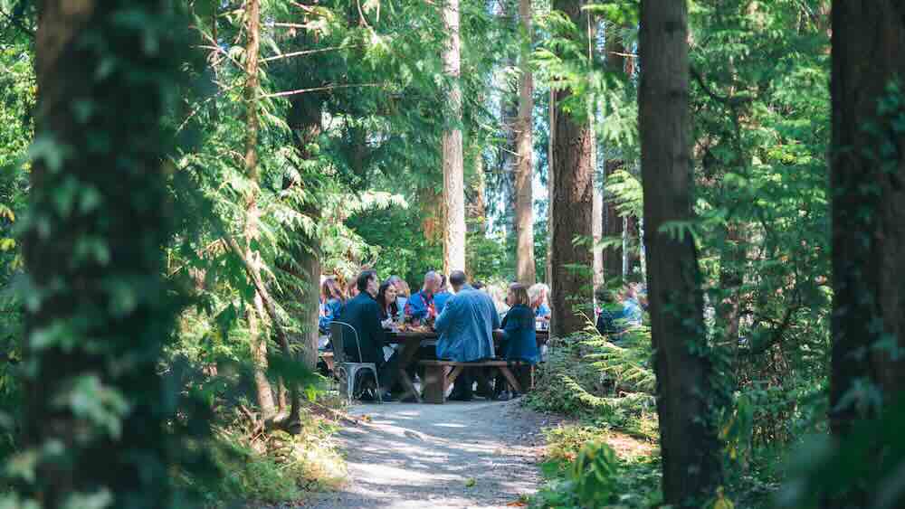 Sea Cider Farm & Ciderhouse, an organic farm where acres of apples are turned into award-winning cider, hosted the group for a memorable meal in the forest. Photo courtesy Destination Canada