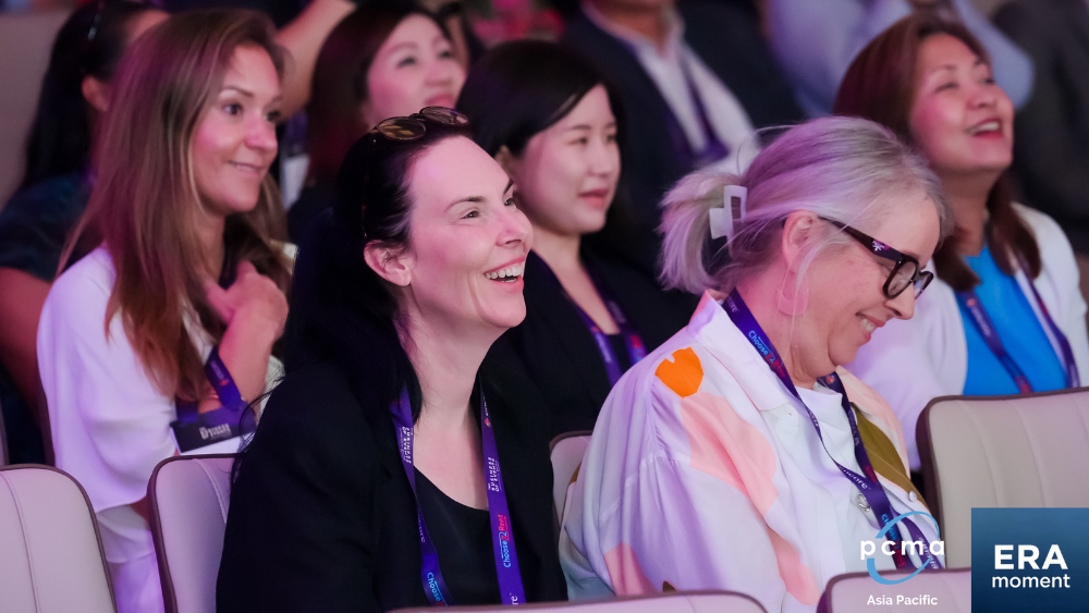 Audience laughing in a session in a conference room