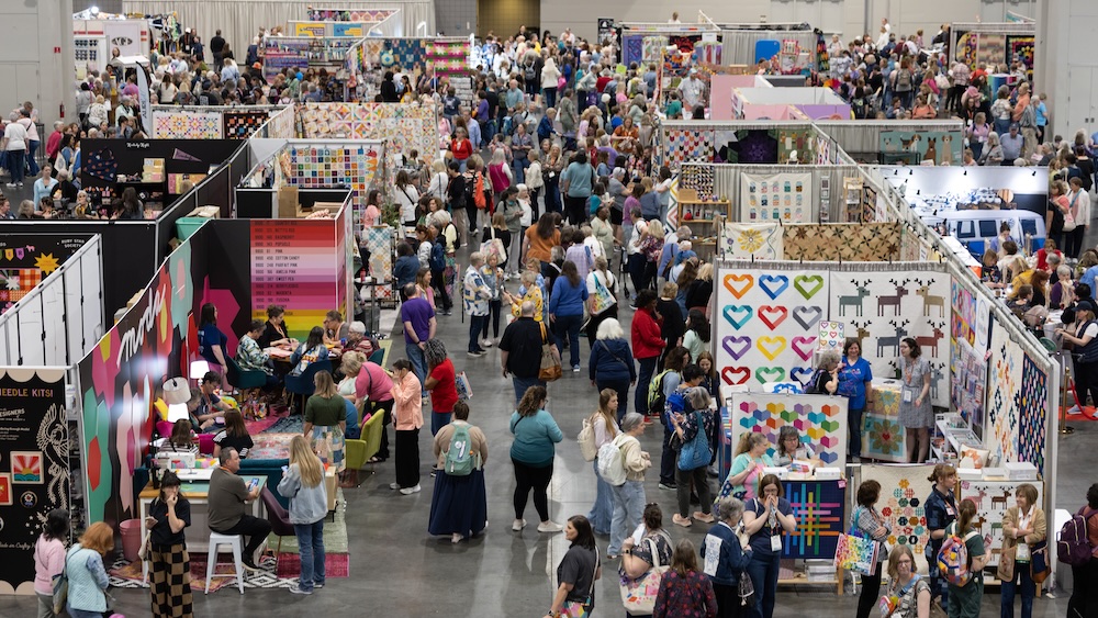 QuiltCon 2026, the world’s largest annual modern quilting event, brought 29,000 attendees in February to the Raleigh Convention Center in Raleigh, North Carolina. The convention included a juried competition, notable this year for dozens of quilts sparking conversations around social issues, a 150,000-square-foot exhibit hall, and 130-plus workshops