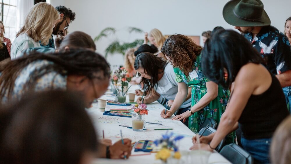 At sessions led by the artist Adam Rosendahl, attendees write and draw directly on butcher-paper covered tables, in conversation with others.